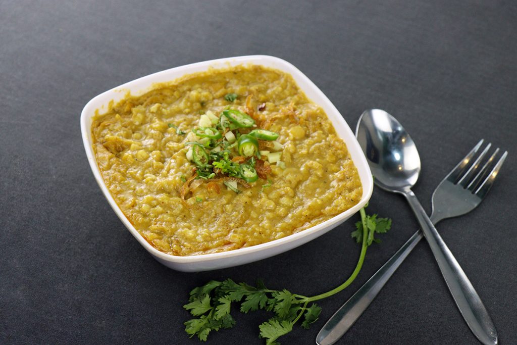 Traditional slow-cooked porridge made with broken wheat, lentils, and tender mutton, simmered with aromatic spices and topped with fried onions, ginger, and ghee.